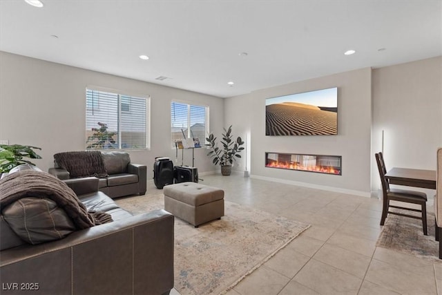 10324 Stroma Ave, Las Vegas, NV 89166 - living room featuring a glass covered fireplace, light tile patterned floors, recessed lighting, and baseboards