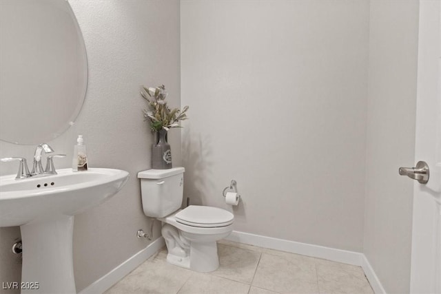 10324 Stroma Ave, Las Vegas, NV 89166 - bathroom with toilet, tile patterned flooring, baseboards, and a sink