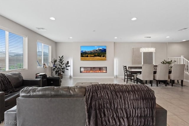 10324 Stroma Ave, Las Vegas, NV 89166 - living area featuring light tile patterned flooring, recessed lighting, a chandelier, and a glass covered fireplace