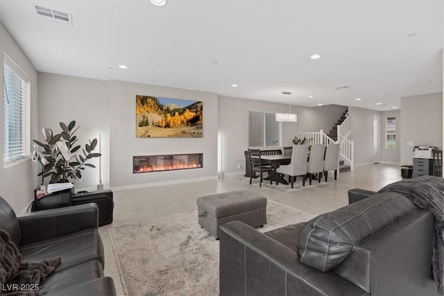 10324 Stroma Ave, Las Vegas, NV 89166 - tiled living area featuring a glass covered fireplace, stairs, recessed lighting, and baseboards