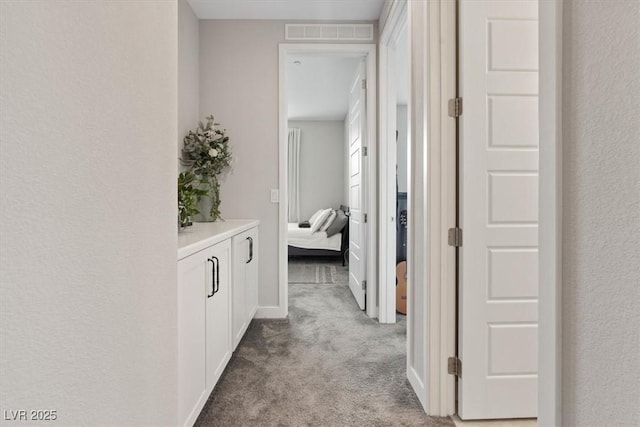 10324 Stroma Ave, Las Vegas, NV 89166 - corridor with light carpet, a textured wall, and baseboards