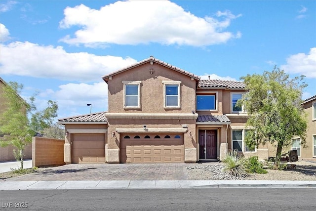 1020 High Altitude Ave, North Las Vegas, NV 89032 - view of front of house featuring a tile roof, stucco siding, driveway, fence, and a garage