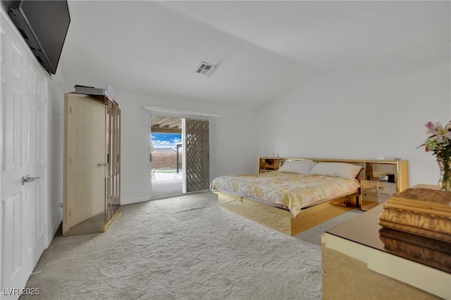 carpeted bedroom featuring access to exterior and vaulted ceiling