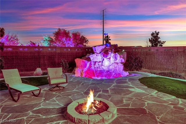 view of patio / terrace with an outdoor fire pit and a fenced backyard