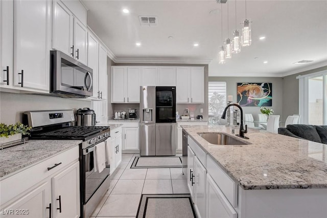 1637 Harvest Pecan Ct, Las Vegas, NV 89108 - kitchen with appliances with stainless steel finishes, a sink, a kitchen island with sink, ornamental molding, and white cabinetry