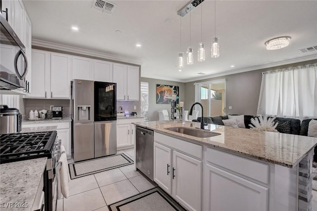 1637 Harvest Pecan Ct, Las Vegas, NV 89108 - kitchen featuring appliances with stainless steel finishes, a sink, crown molding, open floor plan, and white cabinets