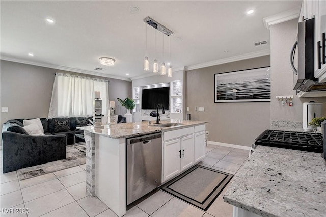 1637 Harvest Pecan Ct, Las Vegas, NV 89108 - kitchen with stainless steel appliances, a sink, open floor plan, white cabinets, and ornamental molding