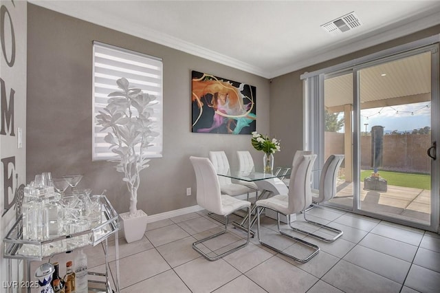 1637 Harvest Pecan Ct, Las Vegas, NV 89108 - dining area featuring crown molding, tile patterned floors, and baseboards