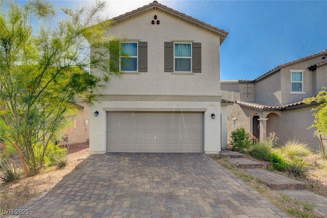 1637 Harvest Pecan Ct, Las Vegas, NV 89108 - mediterranean / spanish house featuring stucco siding, an attached garage, and decorative driveway