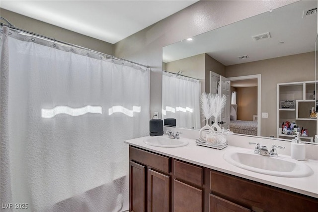 1637 Harvest Pecan Ct, Las Vegas, NV 89108 - ensuite bathroom featuring double vanity and curtained shower