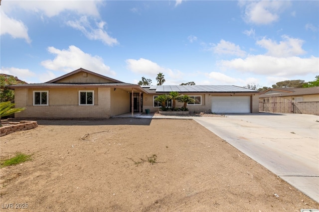3075 Santa Margarita St, Las Vegas, NV 89146 - single story home with a garage, brick siding, roof mounted solar panels, concrete driveway, and fence