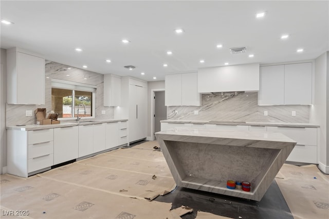 3075 Santa Margarita St, Las Vegas, NV 89146 - kitchen with modern cabinets, a sink, decorative backsplash, white cabinets, and recessed lighting