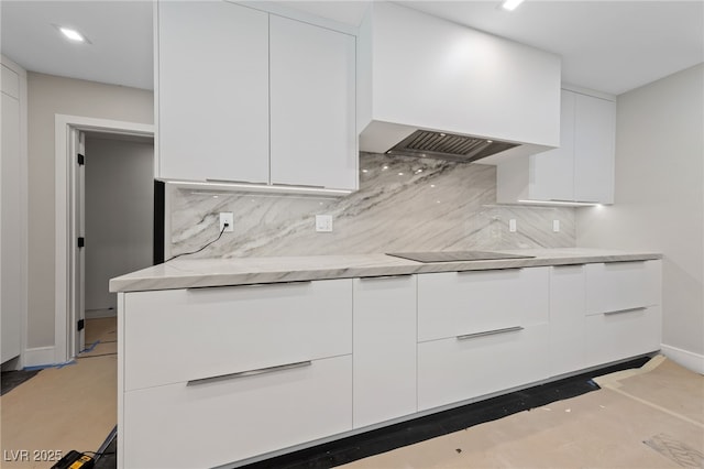 3075 Santa Margarita St, Las Vegas, NV 89146 - kitchen with modern cabinets, black electric cooktop, white cabinets, premium range hood, and decorative backsplash