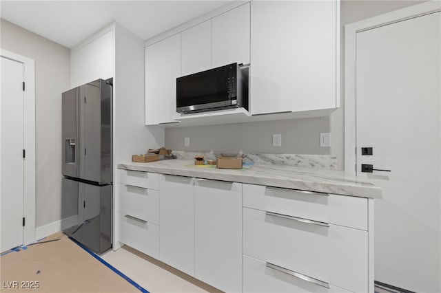 3075 Santa Margarita St, Las Vegas, NV 89146 - kitchen with stainless steel fridge, white cabinetry, and modern cabinets