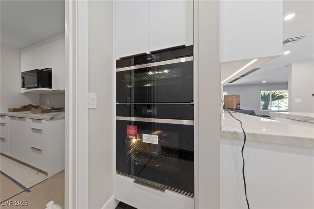3075 Santa Margarita St, Las Vegas, NV 89146 - kitchen view of white cabinets, beverage cooler, modern cabinets, recessed lighting, and light stone countertops
