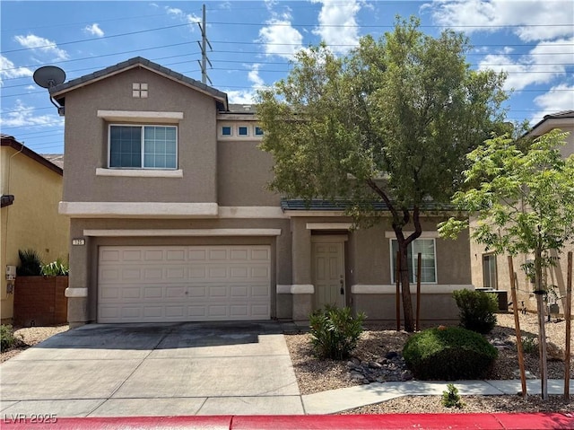 view of front of house with stucco siding, concrete driveway, and an attached garage