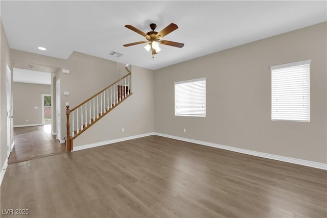 125 Sharp Edge Ave, North Las Vegas, NV 89031 - unfurnished living room featuring stairs, a ceiling fan, wood finished floors, baseboards, and recessed lighting