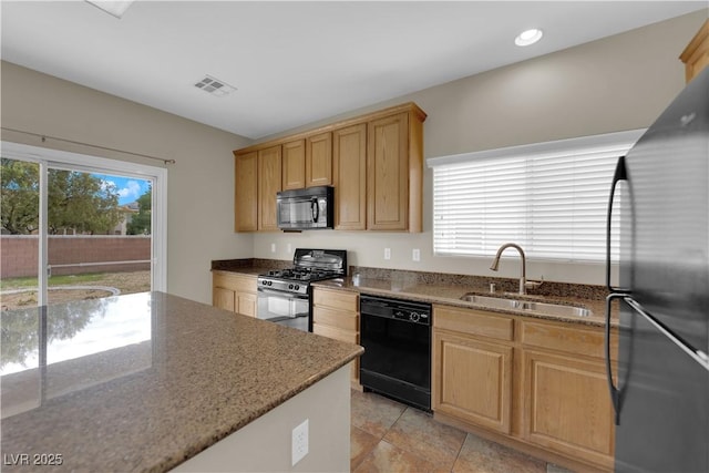 125 Sharp Edge Ave, North Las Vegas, NV 89031 - kitchen with black appliances, a sink, stone countertops, recessed lighting, and light brown cabinets