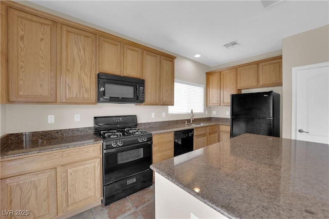 125 Sharp Edge Ave, North Las Vegas, NV 89031 - kitchen with black appliances, a sink, dark stone countertops, light tile patterned floors, and recessed lighting