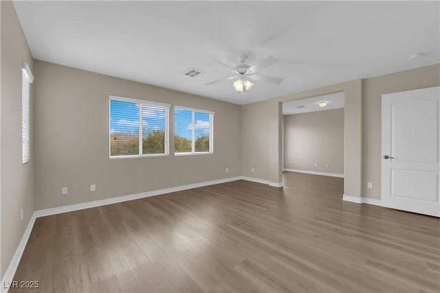 125 Sharp Edge Ave, North Las Vegas, NV 89031 - empty room with a ceiling fan, wood finished floors, and baseboards
