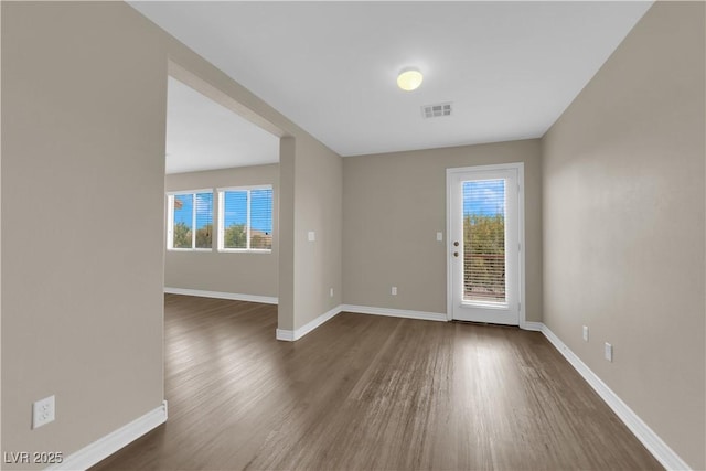 125 Sharp Edge Ave, North Las Vegas, NV 89031 - empty room featuring dark wood-type flooring, plenty of natural light, and baseboards