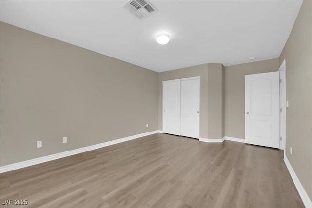 125 Sharp Edge Ave, North Las Vegas, NV 89031 - unfurnished bedroom featuring wood finished floors, baseboards, and a closet