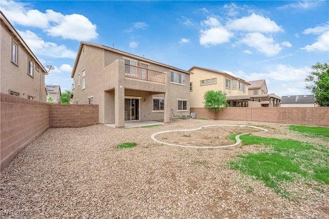 125 Sharp Edge Ave, North Las Vegas, NV 89031 - back of house with a balcony, stucco siding, a fenced backyard, and a patio