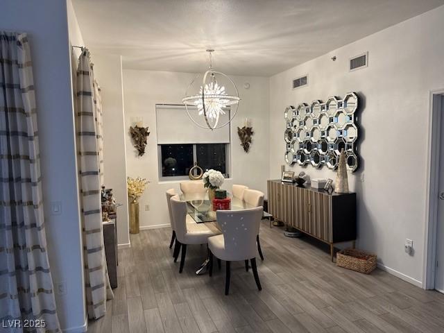 8255 Las Vegas Blvd Unit 611, Las Vegas, NV 89123 - dining room with wood finished floors, a chandelier, and baseboards
