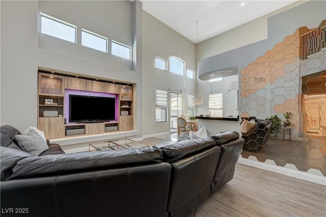 3728 Richard Allen Ct, Las Vegas, NV 89147 - living room featuring a high ceiling, wood finished floors, and baseboards