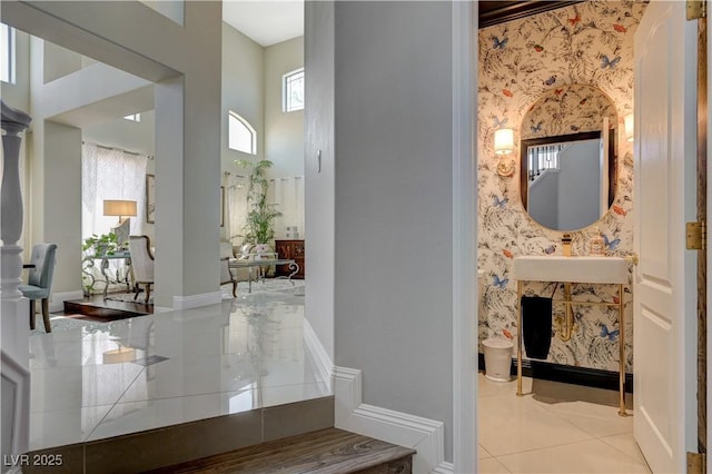 3728 Richard Allen Ct, Las Vegas, NV 89147 - hall with tile patterned floors, healthy amount of natural light, a high ceiling, wallpapered walls, and baseboards