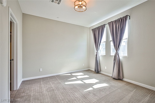 empty room with light carpet and baseboards