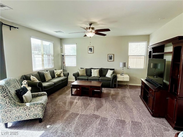 carpeted living room with ceiling fan and baseboards