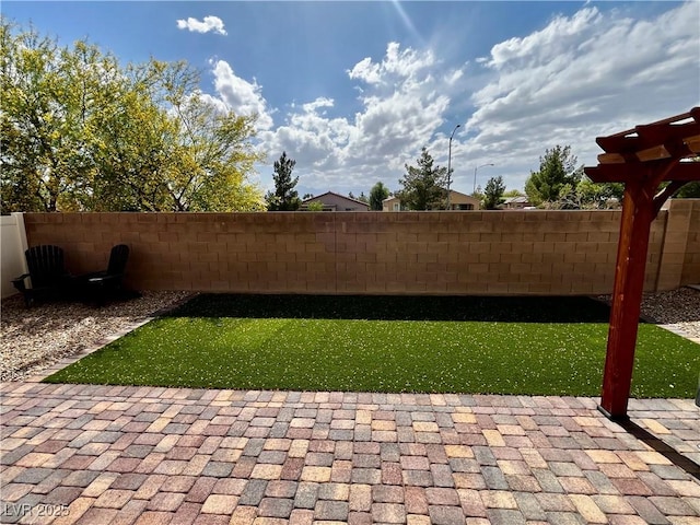 fenced backyard featuring a patio
