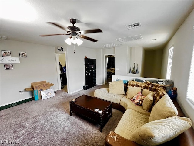 living area featuring carpet floors, a ceiling fan, and baseboards