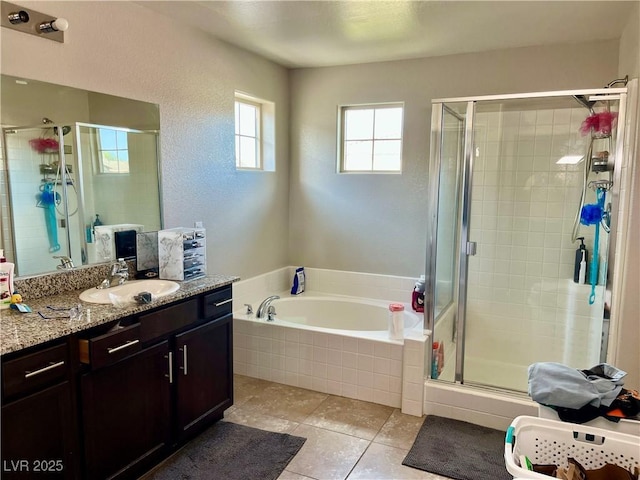 full bath with tile patterned floors, a shower stall, a garden tub, and vanity