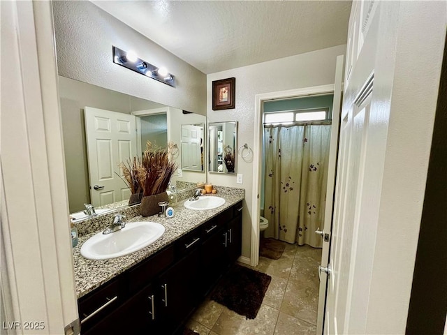full bath featuring toilet, tile patterned flooring, double vanity, and a shower with curtain