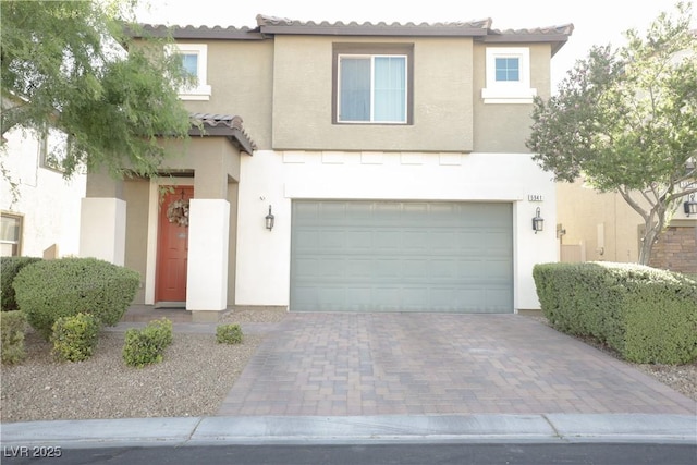 5941 Galway Bay St, North Las Vegas, NV 89081 - view of property featuring stucco siding, an attached garage, decorative driveway, and a tiled roof