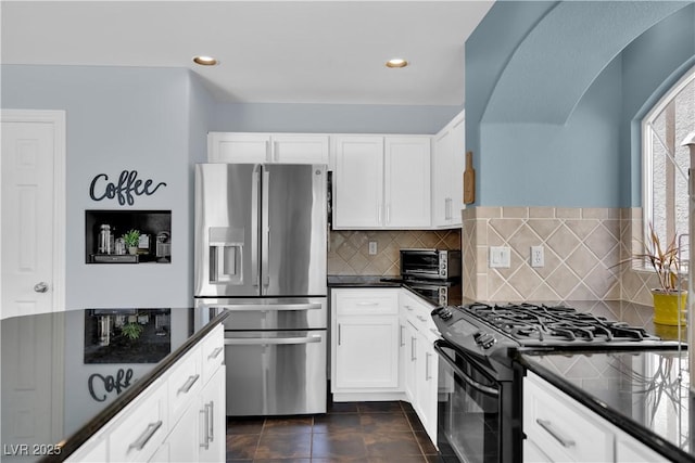 10902 Fintry Hills St, Las Vegas, NV 89141 - kitchen with stainless steel fridge, black range with gas stovetop, white cabinets, tasteful backsplash, and recessed lighting