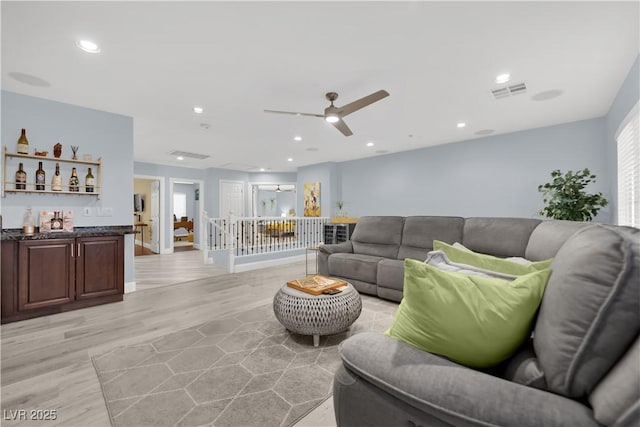 10902 Fintry Hills St, Las Vegas, NV 89141 - living area with light wood-style flooring, ceiling fan, recessed lighting, bar area, and baseboards