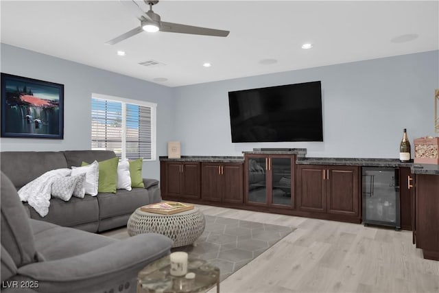 10902 Fintry Hills St, Las Vegas, NV 89141 - living room featuring beverage cooler, light wood finished floors, a bar, ceiling fan, and recessed lighting
