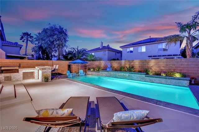 10902 Fintry Hills St, Las Vegas, NV 89141 - view of pool featuring a fenced backyard, a patio area, and an outdoor kitchen