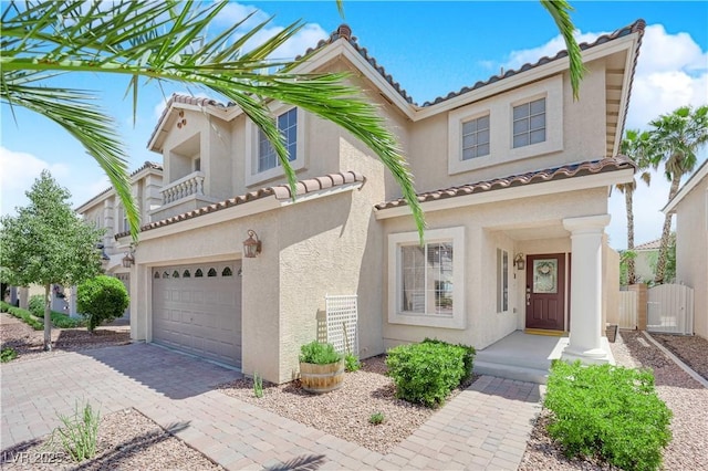 10902 Fintry Hills St, Las Vegas, NV 89141 - mediterranean / spanish home featuring an attached garage, stucco siding, a tile roof, driveway, and fence