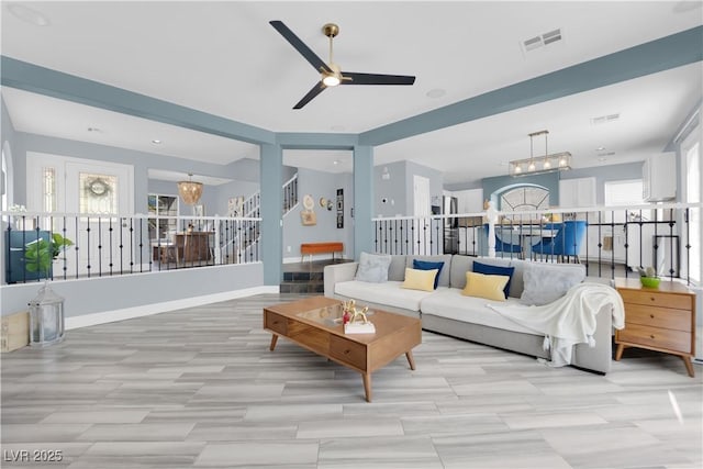 10902 Fintry Hills St, Las Vegas, NV 89141 - living area featuring a ceiling fan, a chandelier, and stairway