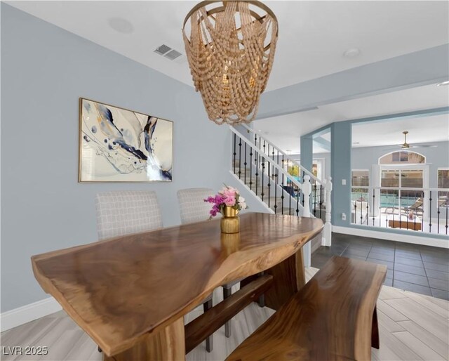 10902 Fintry Hills St, Las Vegas, NV 89141 - dining space featuring a chandelier, stairs, and baseboards