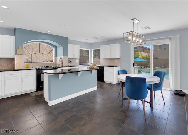 10902 Fintry Hills St, Las Vegas, NV 89141 - kitchen featuring plenty of natural light, black appliances, dark countertops, tasteful backsplash, and recessed lighting