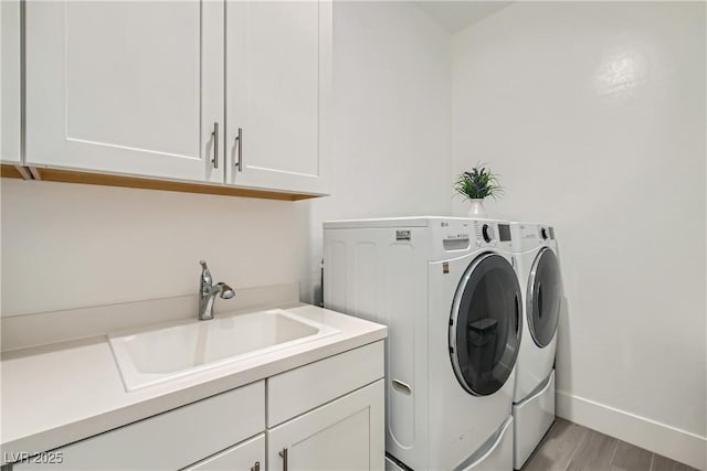 5321 Brayden Ct, Las Vegas, NV 89131 - laundry room with separate washer and dryer, cabinet space, light wood finished floors, and baseboards