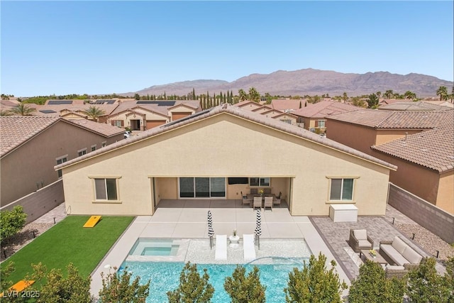 5321 Brayden Ct, Las Vegas, NV 89131 - back of property featuring stucco siding, an outdoor living space, an in-ground hot tub, and a patio