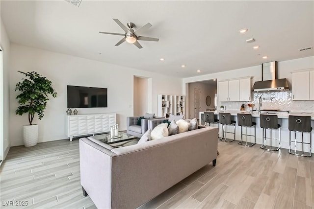 5321 Brayden Ct, Las Vegas, NV 89131 - living area featuring ceiling fan, light wood-style floors, and recessed lighting