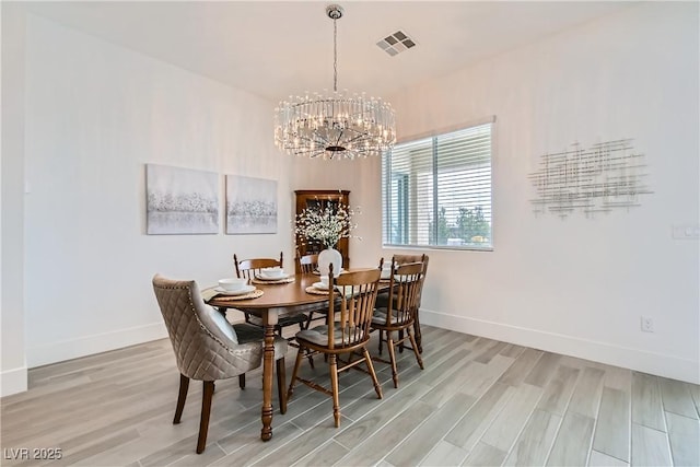 5321 Brayden Ct, Las Vegas, NV 89131 - dining room with a chandelier, light wood finished floors, and baseboards