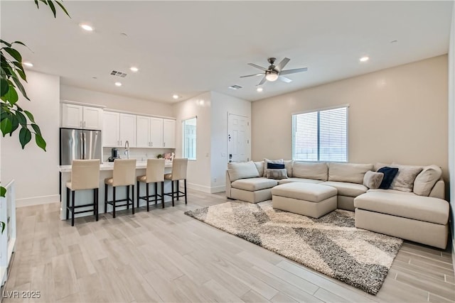 5321 Brayden Ct, Las Vegas, NV 89131 - living area featuring a ceiling fan, plenty of natural light, light wood-style floors, baseboards, and recessed lighting
